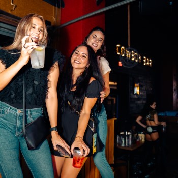 Three women dancing at PBR Cowboy Bar at Live! at the Pointe Orlando.